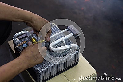 Car air conditioner evaporator coil close up.â€¨ Auto mechanic worker fixing air condition in car garage..MaintenanceÂ service, Stock Photo